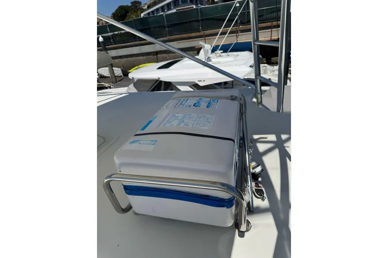 Slide: The Image of 1998 Cabo Yachts 35 Express deck with mounted equipment in marina setting. - 52