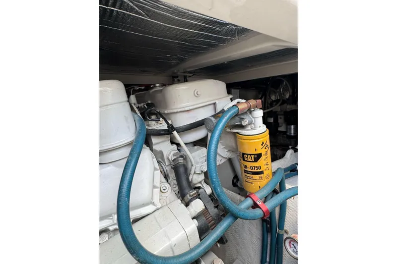 Slide: The Image of Engine compartment of a 1998 Cabo Yachts 35 Express with CAT filter and hoses. - 53