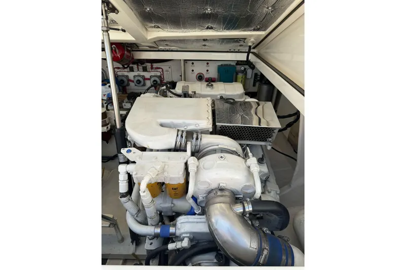 Slide: The Image of Engine room of a 1998 Cabo Yachts 35 Express, showcasing detailed machinery and components. - 54