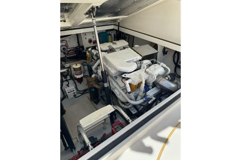 Slide: The Image of Engine room of a 1998 Cabo Yachts 35 Express, showcasing mechanical components. - 55