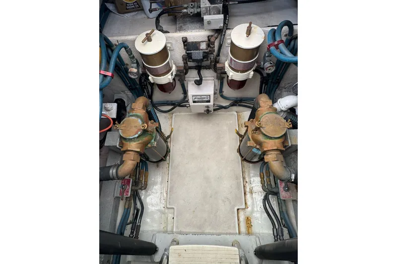 Slide: The Image of Engine compartment of a 1998 Cabo Yachts 35 Express, showcasing mechanical components and filters. - 57