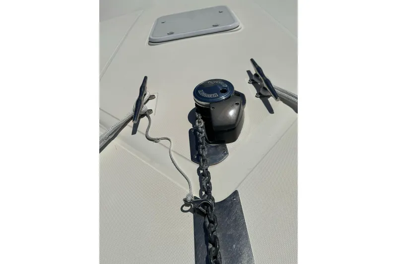 Slide: The Image of Anchor winch and cleats on 1998 Cabo Yachts 35 Express deck. - 58
