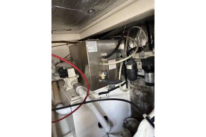 Slide: The Image of Engine room of 1998 Cabo Yachts 35 Express, showcasing mechanical components and wiring. - 59