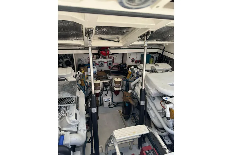 Slide: The Image of Engine room of a 1998 Cabo Yachts 35 Express, showcasing mechanical components and systems. - 61