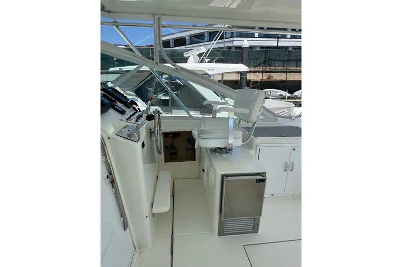 Slide: The Image of 1998 Cabo Yachts 35 Express helm with captain's chair and control panel. - 63