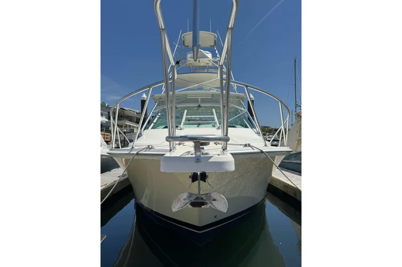 Slide: The Image of 1998 Cabo Yachts 35 Express docked, front view with clear blue sky. - 7