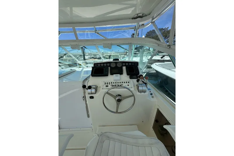 Slide: The Image of Helm of 1998 Cabo Yachts 35 Express, featuring steering wheel and control panel. - 71