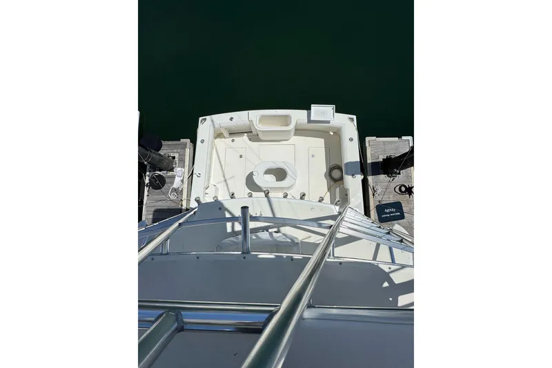 Slide: The Image of 1998 Cabo Yachts 35 Express boat docked, viewed from above, showcasing spacious deck layout. - 8