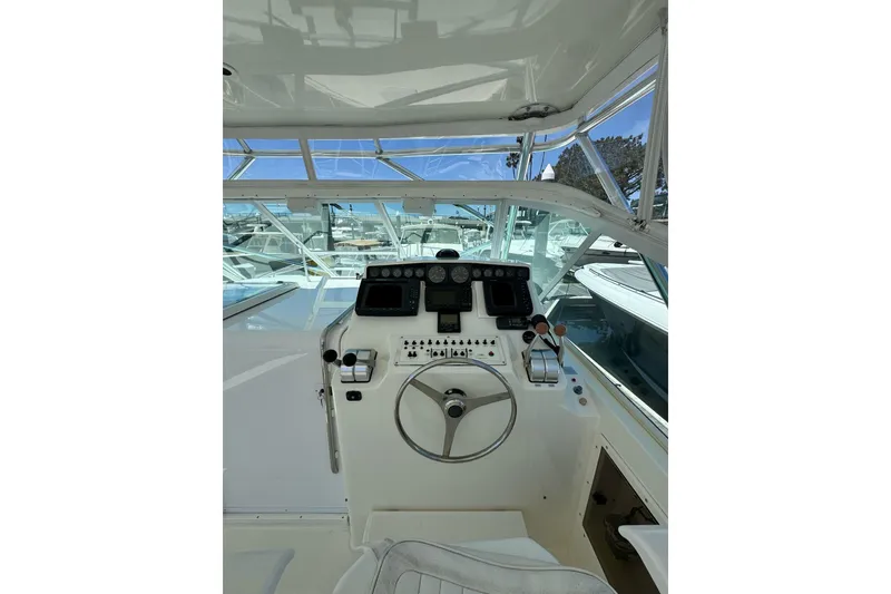 Slide: The Image of Helm of 1998 Cabo Yachts 35 Express with steering wheel and control panel. - 9