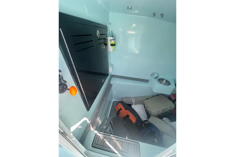 Slide: The Image of Interior of 2024 Front Runner boat with storage, sink, and equipment. - 10