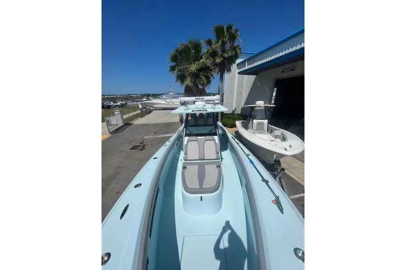 Slide: The Image of 2024 Front Runner boat docked, showcasing sleek design and modern features under clear blue sky. - 12