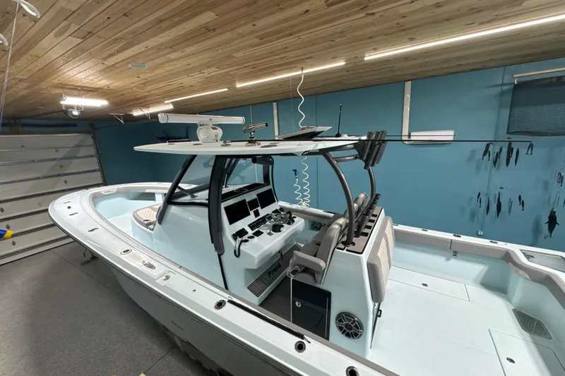 Slide: The Image of 2024 Front Runner boat in a garage with wooden ceiling and blue walls. - 7