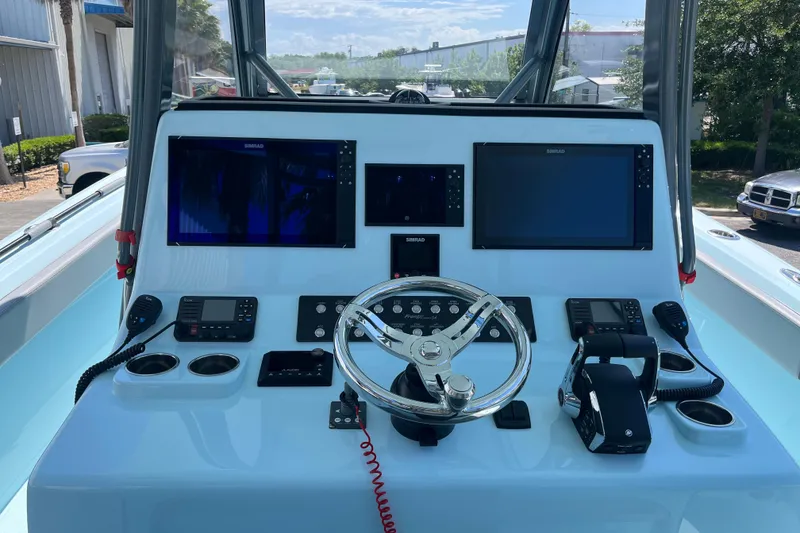 Slide: The Image of 2024 Front Runner boat dashboard with steering wheel, navigation screens, and control panels. - 9