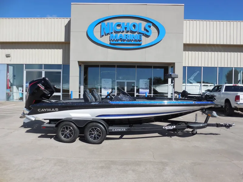 The Image of A 2027 Caymas CX 201 PRO on a trailer in front of a building with a "Nichols Marine" sign. - 1