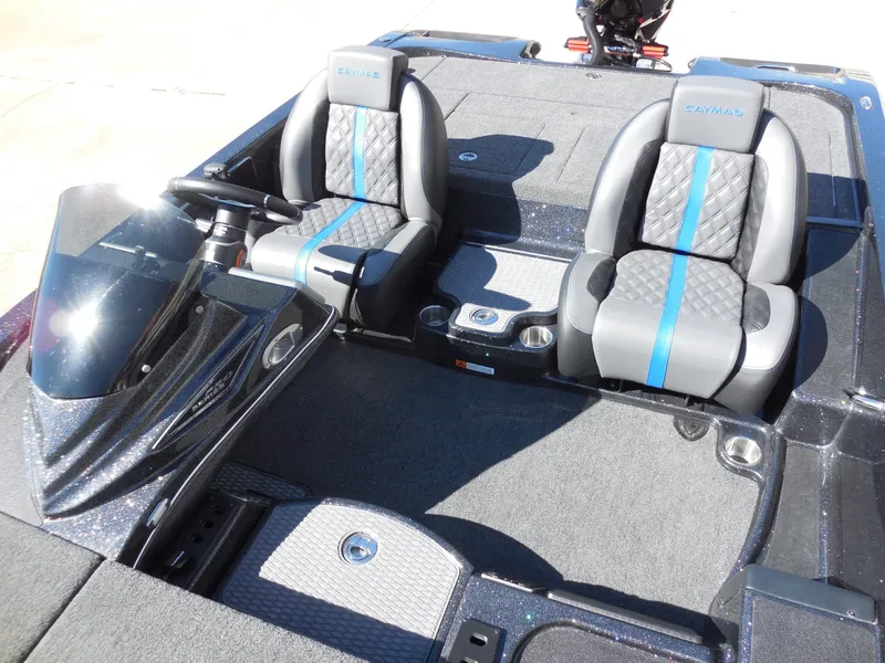 Slide: The Image of The image shows the cockpit of a Caymas CX 201 PRO boat with two cushioned seats. - 18