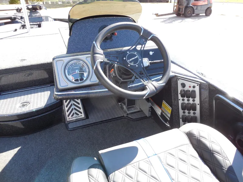 Slide: The Image of The image shows the cockpit of a Caymas CX 201 PRO boat with a modern steering wheel and instruments. - 14