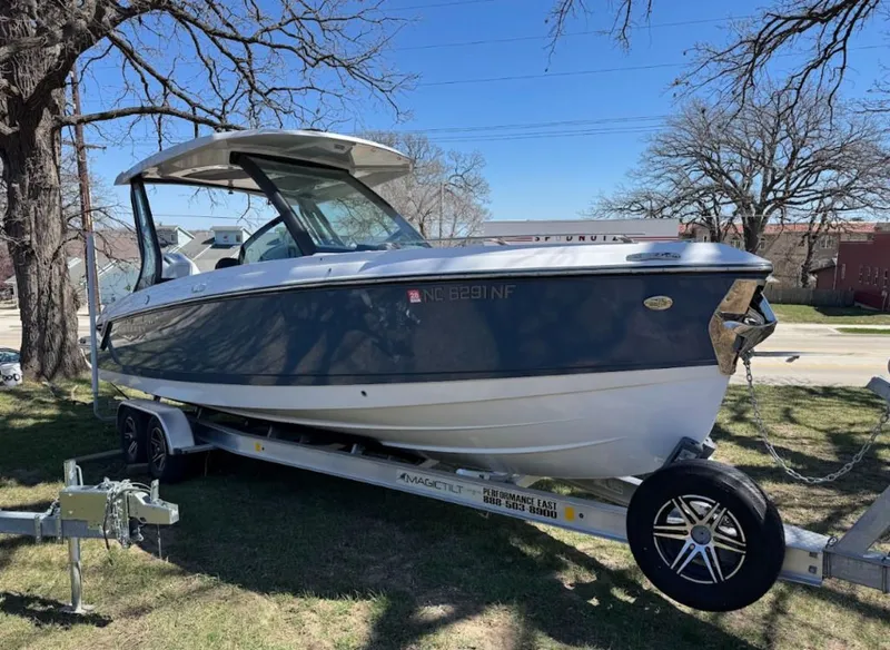 The Image of 2025 Monterey Elite 27 OB boat on trailer outdoors. - 0