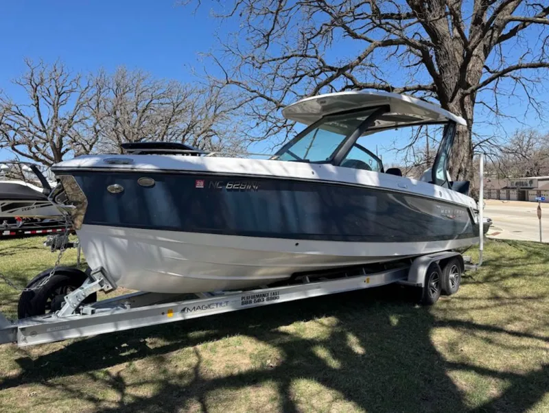 Slide: The Image of 2025 Monterey Elite 27 OB boat on trailer outdoors. - 3