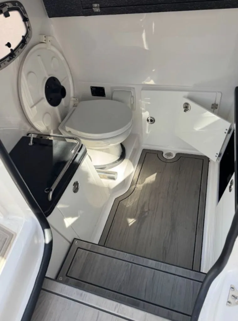 Slide: The Image of Interior of 2025 Monterey Elite 27 OB with toilet and storage. - 7