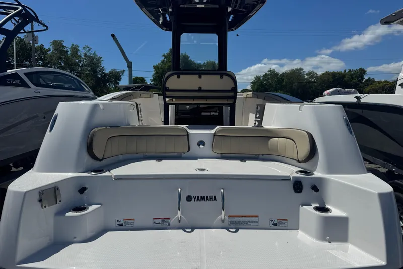 Slide: The Image of 2026 Yamaha Boats 255 FSH Sport E, rear view, showcasing seating and deck features. - 2