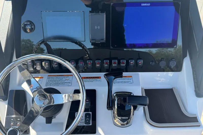Slide: The Image of Control panel of 2026 Yamaha Boats 255 FSH Sport E with steering wheel and digital displays. - 7