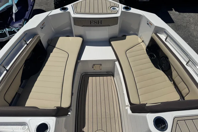 Slide: The Image of 2026 Yamaha Boats 255 FSH Sport E interior with beige seating and deck. - 13