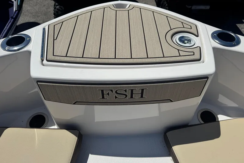 Slide: The Image of 2026 Yamaha Boats 255 FSH Sport E deck with cup holders and seating. - 14