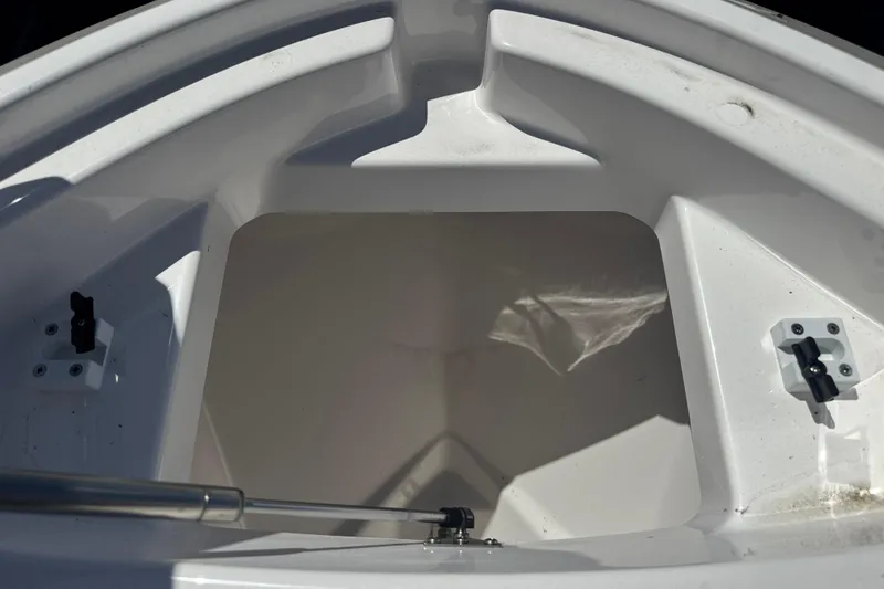 Slide: The Image of Storage compartment of 2026 Yamaha Boats 255 FSH Sport E, featuring sleek white interior design. - 15