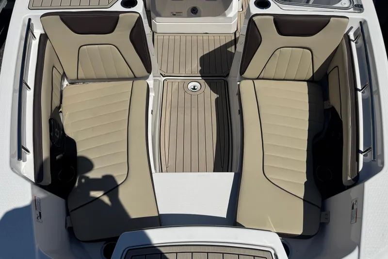 Slide: The Image of 2026 Yamaha Boats 255 FSH Sport E interior seating, featuring beige and brown cushioned seats. - 16