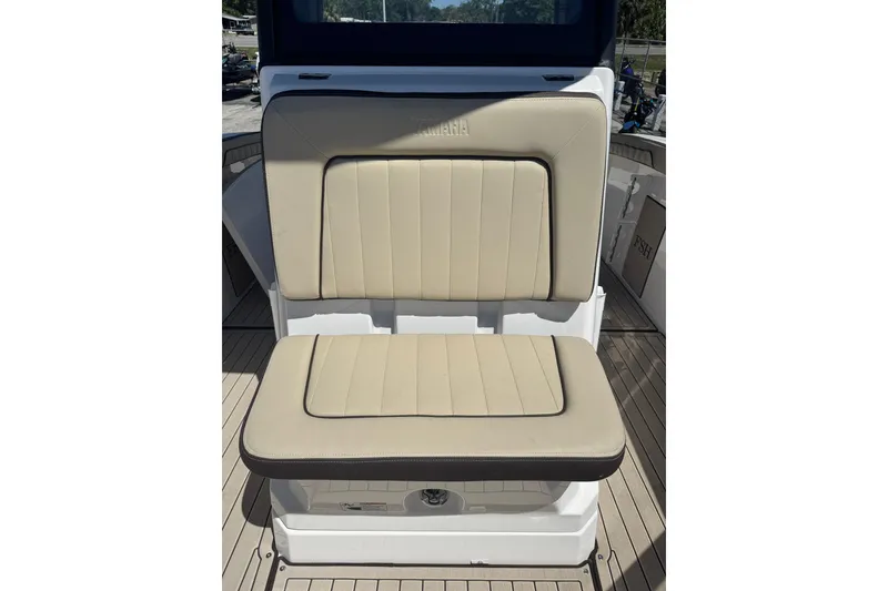 Slide: The Image of 2026 Yamaha Boats 255 FSH Sport E, beige cushioned seating on deck. - 21