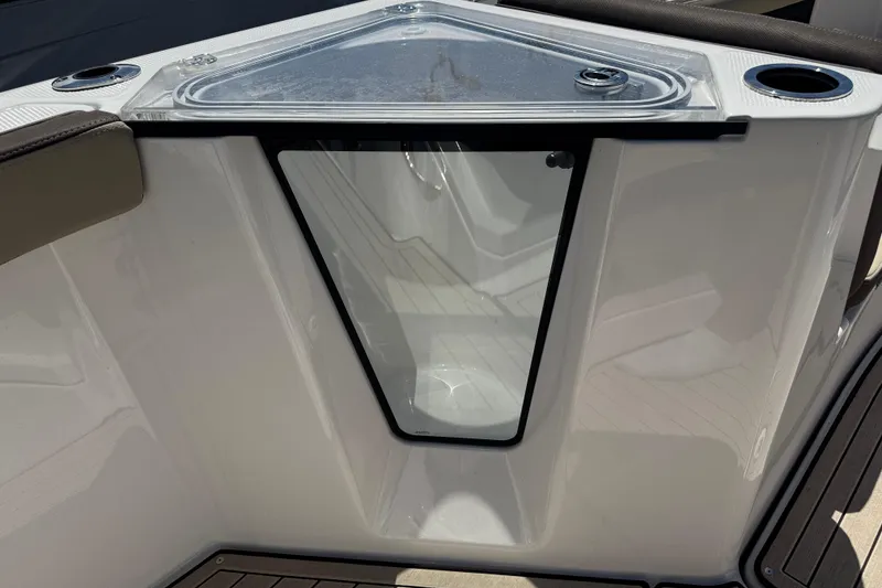 Slide: The Image of Yamaha Boats 2026 255 FSH Sport E, interior detail with storage compartment and cup holders. - 22