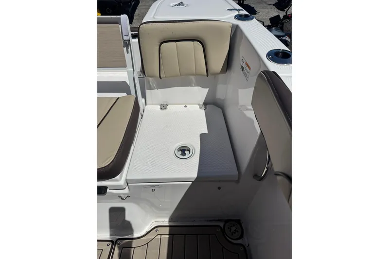 Slide: The Image of 2026 Yamaha Boats 255 FSH Sport E interior seating with cup holders and storage. - 29