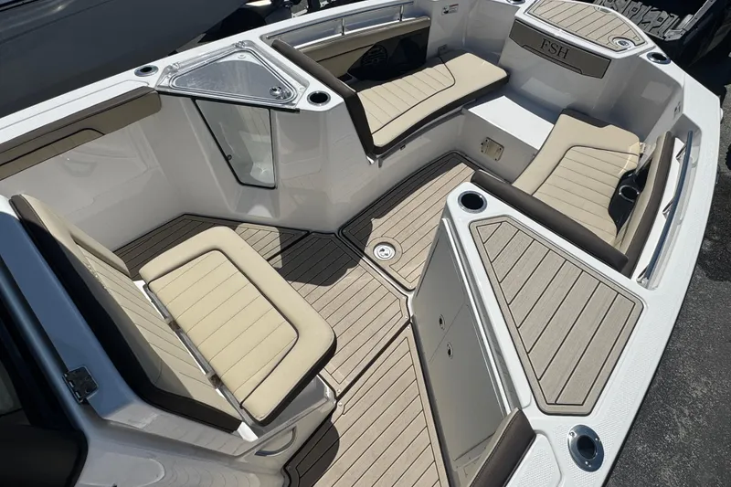 Slide: The Image of 2026 Yamaha Boats 255 FSH Sport E interior with beige seating and sleek design. - 10