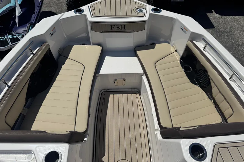 Slide: The Image of 2026 Yamaha Boats 255 FSH Sport E interior with beige seating and sleek design. - 13