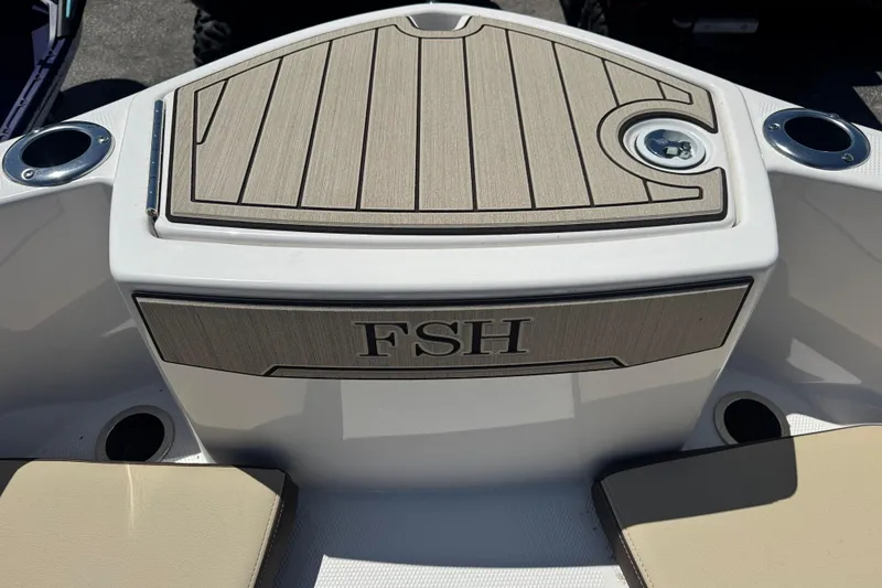 Slide: The Image of 2026 Yamaha Boats 255 FSH Sport E deck with cup holders and seating. - 14