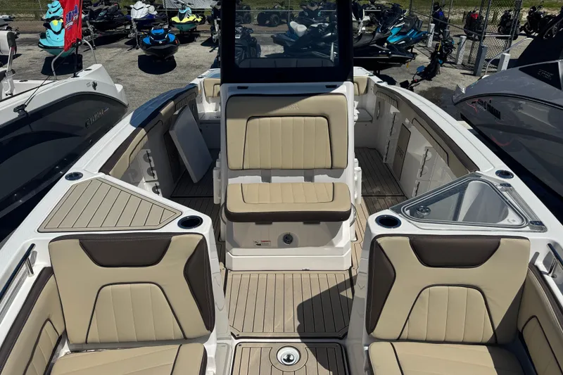 Slide: The Image of 2026 Yamaha Boats 255 FSH Sport E interior with beige seating and deck layout. - 17