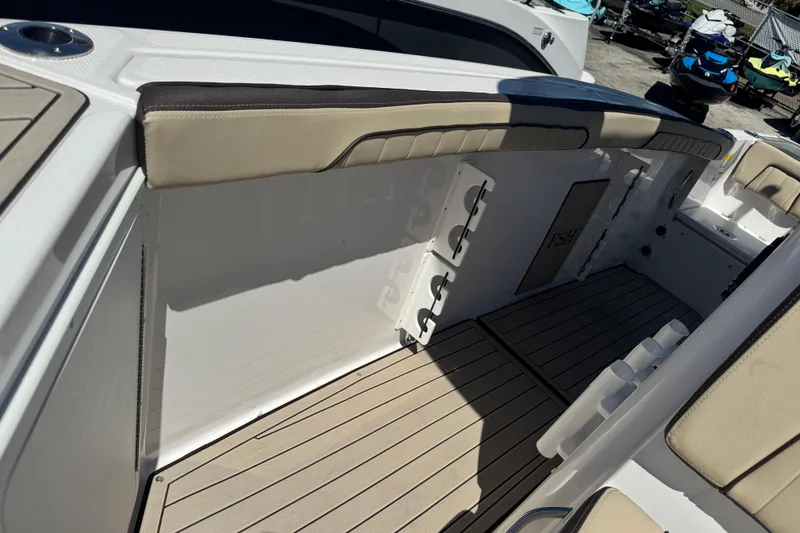 Slide: The Image of 2026 Yamaha Boats 255 FSH Sport E interior with cushioned seating and rod holders. - 26