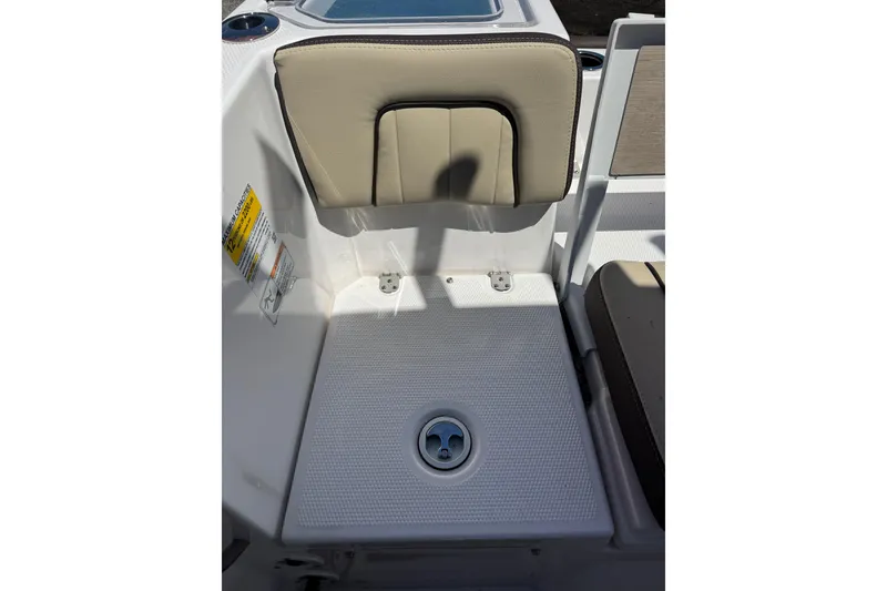 Slide: The Image of Yamaha Boats 2026 255 FSH Sport E seating area with beige cushion and deck drain. - 30