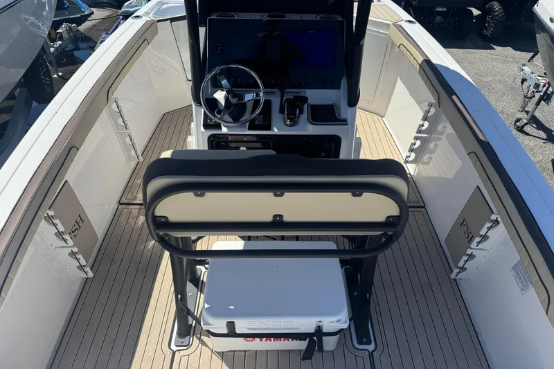 Slide: The Image of 2026 Yamaha Boats 255 FSH Sport E interior with steering console and seating. - 4