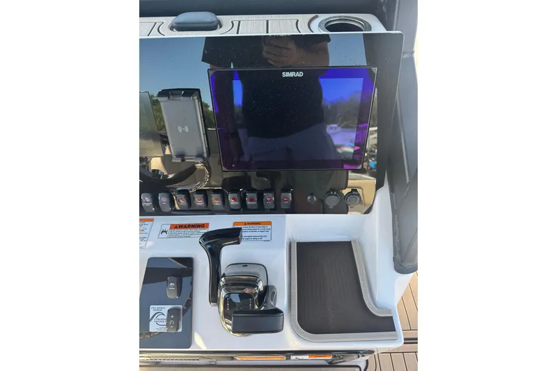 Slide: The Image of Control panel of 2026 Yamaha Boats 255 FSH Sport E with Simrad display and controls. - 8