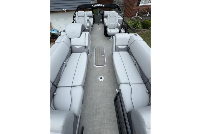 Slide: The Image of 2024 Regency 230 DL3 pontoon boat with spacious seating and modern design. - 12
