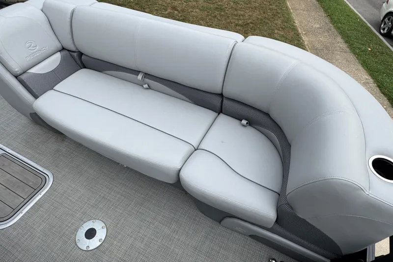 Slide: The Image of Luxurious seating on 2024 Regency 230 DL3 pontoon boat, featuring plush gray upholstery. - 14