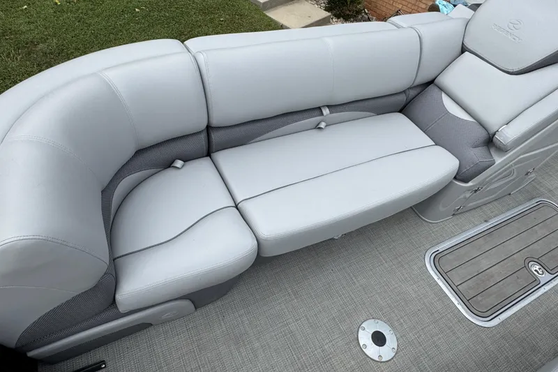 Slide: The Image of 2024 Regency 230 DL3 boat interior with plush gray seating and textured flooring. - 15