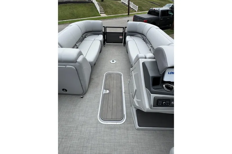 Slide: The Image of 2024 Regency 230 DL3 pontoon boat interior with gray seating and modern dashboard. - 16
