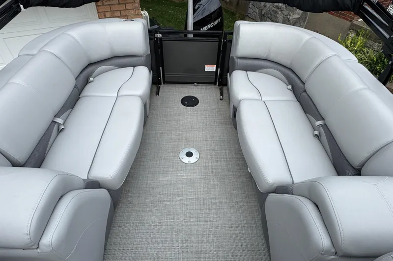 Slide: The Image of 2024 Regency 230 DL3 pontoon boat interior with plush gray seating. - 17