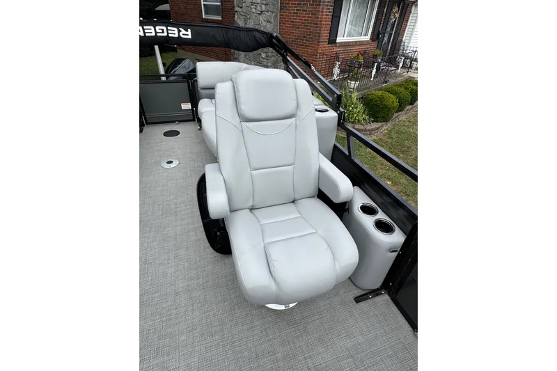 Slide: The Image of Luxurious captain's chair on 2024 Regency 230 DL3 pontoon boat, featuring cup holders and sleek design. - 20