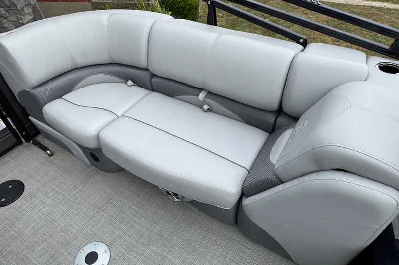 Slide: The Image of 2024 Regency 230 DL3 boat interior with plush gray seating and modern design. - 21