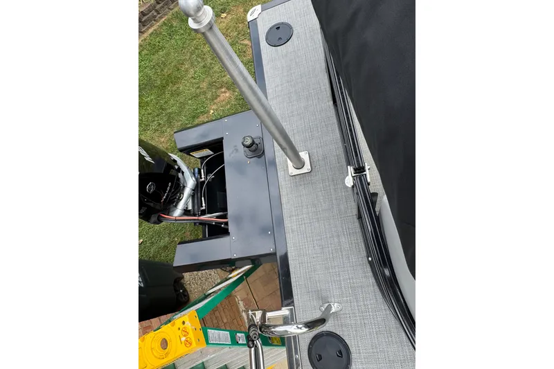 Slide: The Image of 2024 Regency 230 DL3 boat deck with motor and railing, viewed from above. - 26