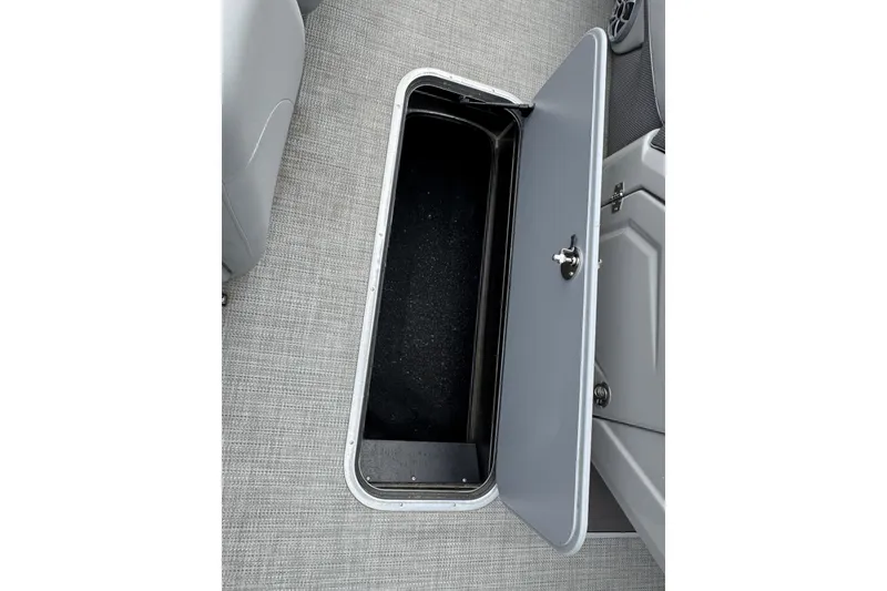 Slide: The Image of Open storage compartment on 2024 Regency 230 DL3 boat, featuring sleek gray interior design. - 31