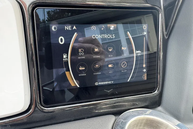 Slide: The Image of Touchscreen control panel of 2024 Regency 230 DL3 boat, displaying navigation and system settings. - 36